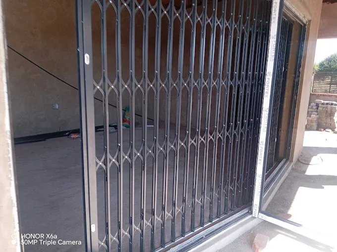 Expanding steel security gate, fitted by J&L